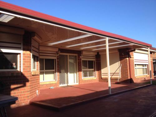 Custom Flat Roofed Patio wrapped around a Bay Window